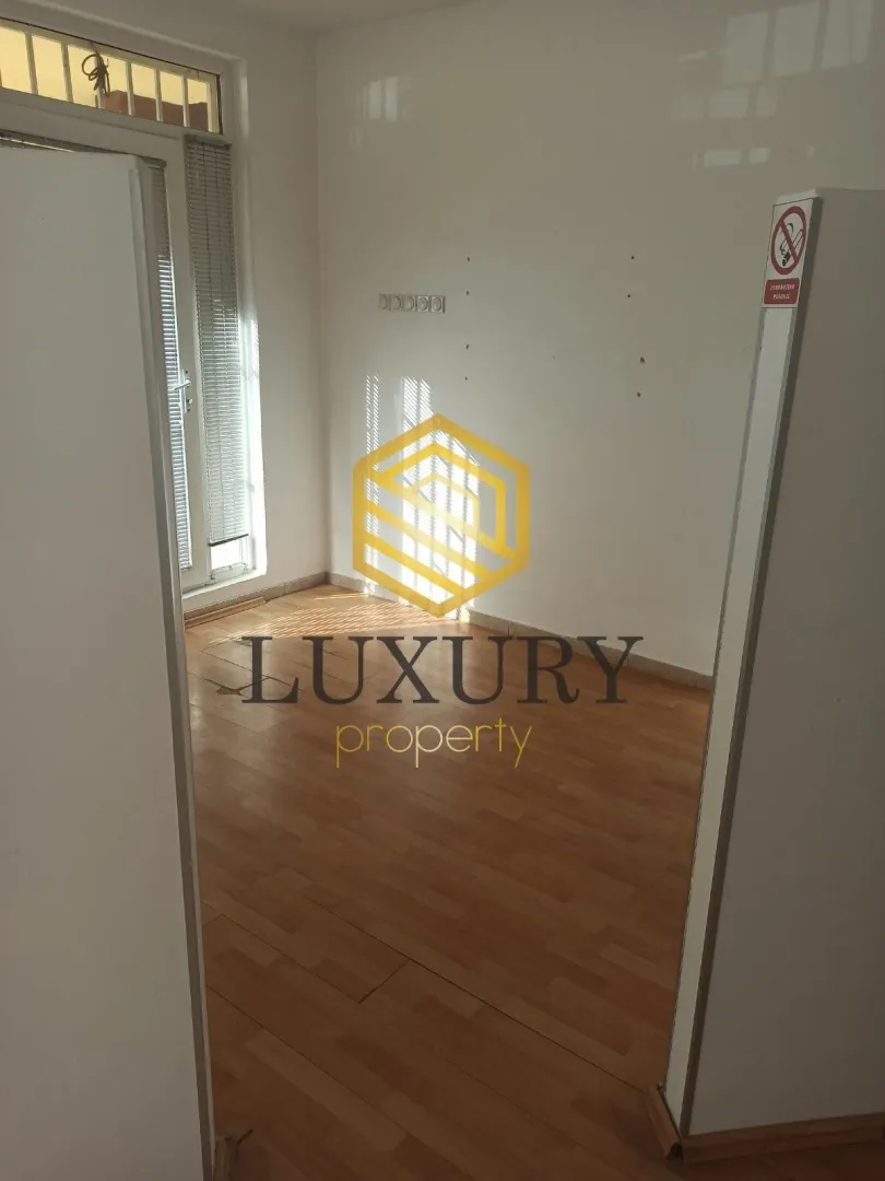 Empty room with parquet flooring and white walls.