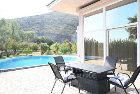 Terrace with outdoor seating furniture and a view of the swimming pool and yard. - image 31
