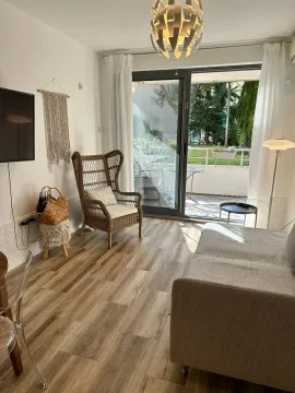 Living room with a sofa, armchair, and access to the terrace. - image 5
