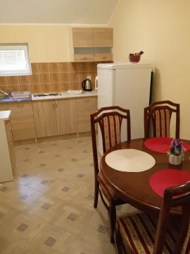 Kitchen with a dining table and wooden elements. - image 4