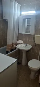 Smaller bathroom with a bathtub, washbasin, toilet, and mirrored cabinet. - image 10