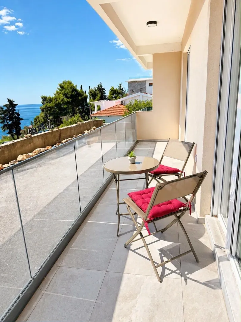 Spacious balcony with outdoor seating and a sea view.