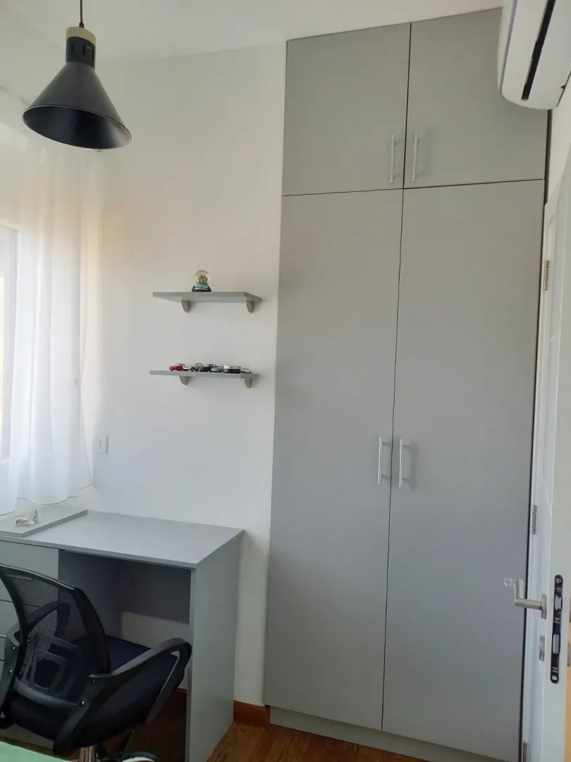 Manja spavaća soba sa ugradnim plakarom, radnim stolom i policama.