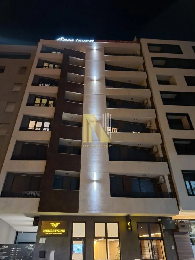 Night view of the facade of a modern apartment building with lighting.