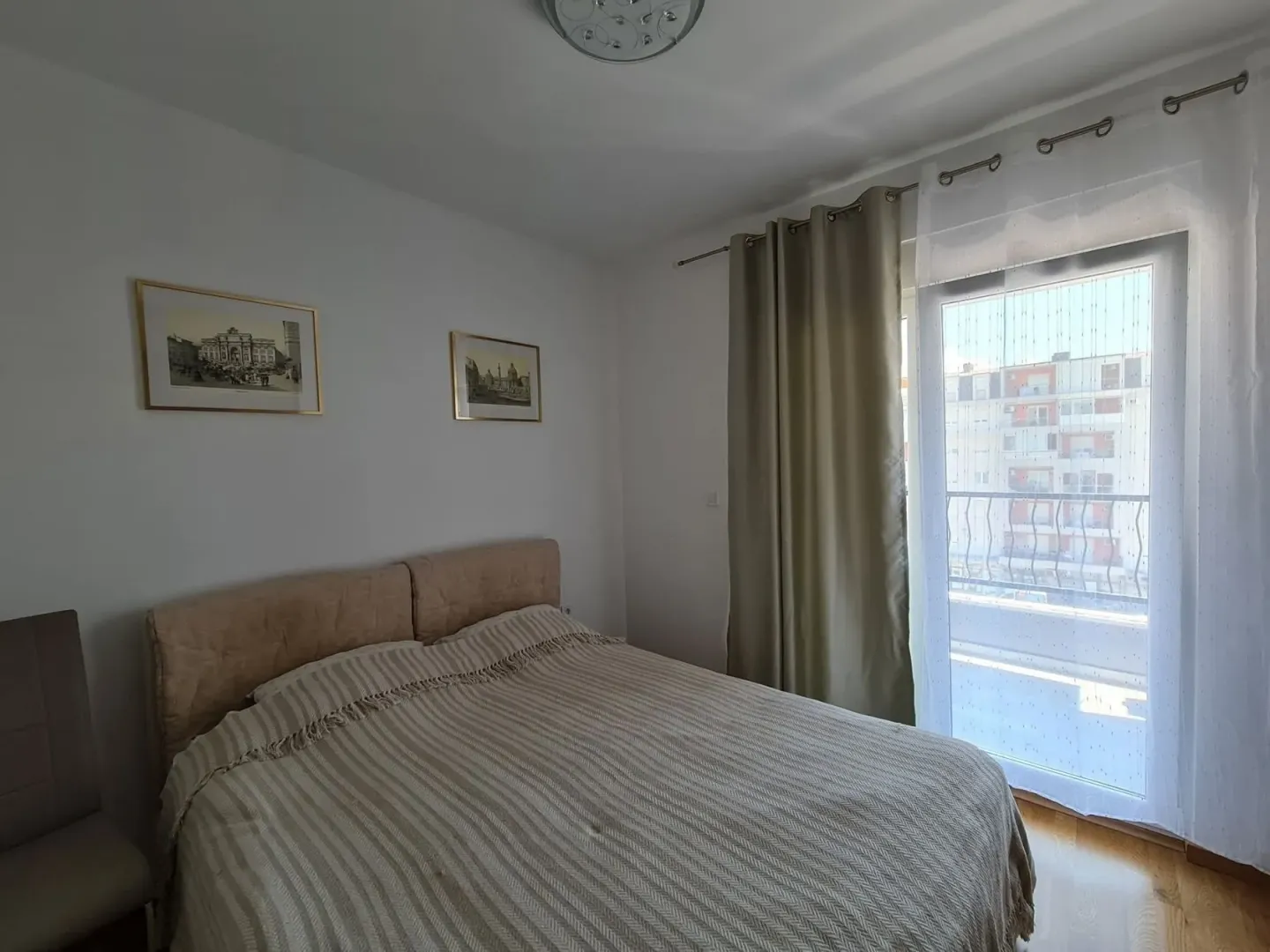 Bedroom with a double bed and balcony access.