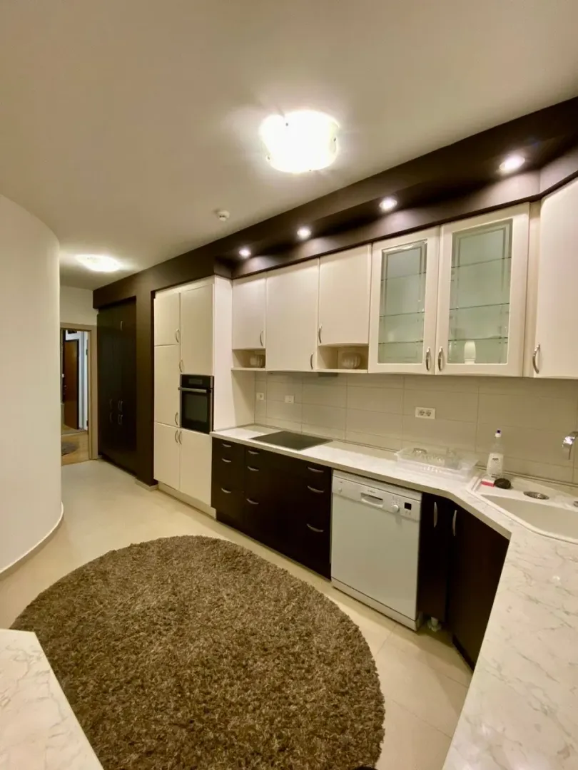 Modern kitchen with white and dark cabinets.