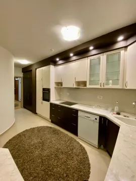 Modern kitchen with white and dark cabinets. - image 4