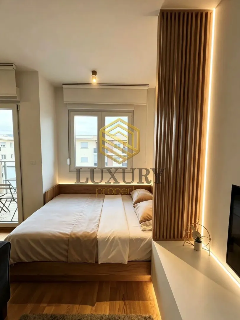 Modern bedroom with a double bed and wooden wall panels with LED lighting.