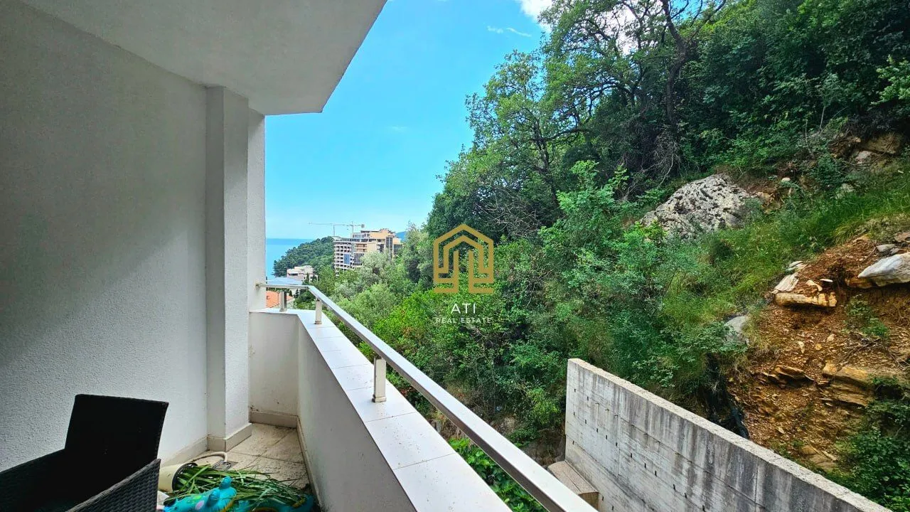View from the terrace overlooking greenery and surrounding buildings.