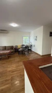 Living room with a sofa and dining area. - image 10