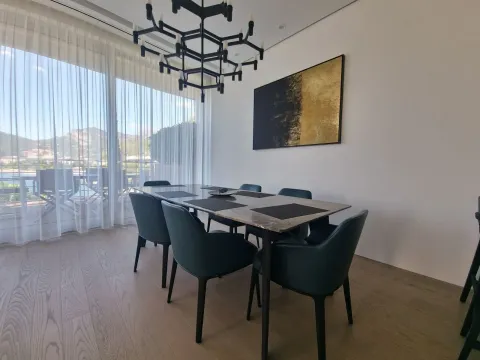 Dining area with a large table, comfortable chairs, and access to the terrace. - image 25