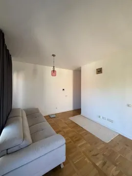 Living room with a sofa and parquet flooring. - image 2