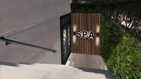 Ulaz u spa centar sa natpisom na zidu i stepeništem. - image 10