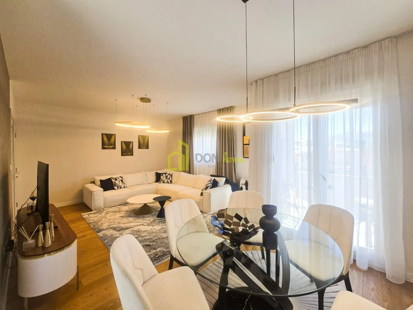 Spacious living room with sofa set and dining area.