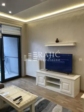 Living room with a TV and access to the terrace. - image 2
