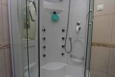 A modern shower cabin with massage jets in a bathroom. - image 15