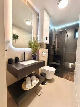 Modern bathroom with a shower cabin, washbasin, and toilet. - image 9