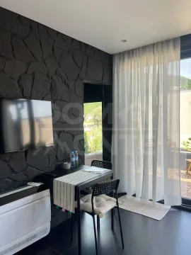 Living room with a dining table and access to the terrace. - image 16