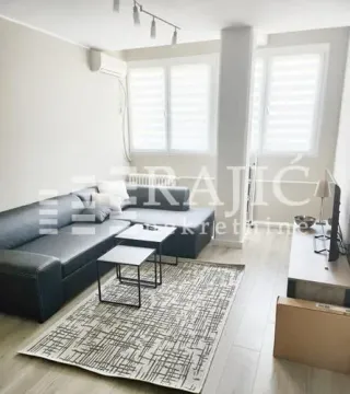 Living room with sofa, coffee table and TV unit. - image 2