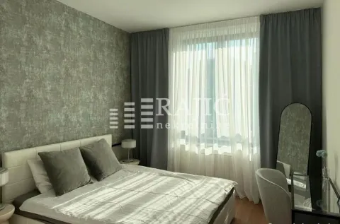 Furnished bedroom with a double bed and a window with dark curtains. - image 10