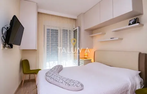 Furnished bedroom with a double bed, built-in cabinetry, and balcony access. - image 3