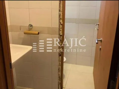 View of the bathroom with ceramic tiles and a washbasin. - image 18