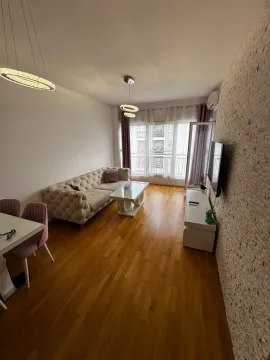 Living room with sofa, dining table, and TV unit. - image 2
