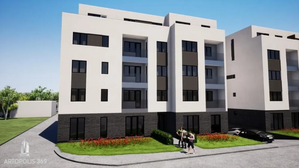 Spoljašnji izgled moderne stambene zgrade sa uređenim dvorištem.