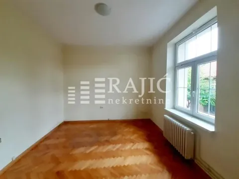 Empty room with parquet flooring and a window. - image 5