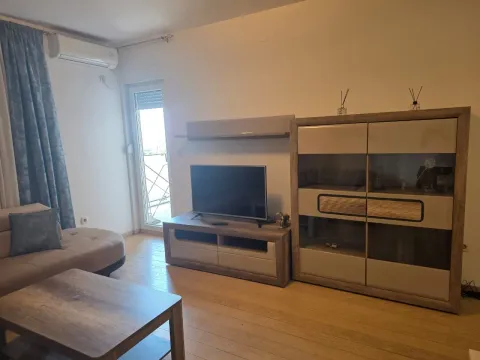 Living room with a sofa, TV, and access to the terrace. - image 11