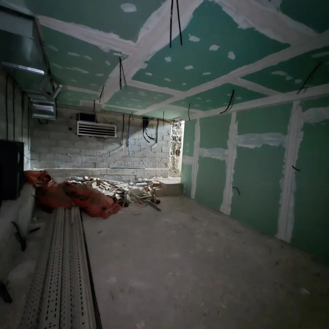 Room under renovation with drywall and construction debris.