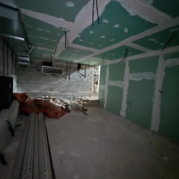 Room under renovation with drywall and construction debris. - image 8