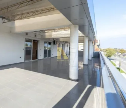Spacious covered terrace with columns and a street view. - image 7