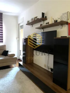 Living room with a TV unit and shelves. - image 9