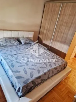 Furnished bedroom with a double bed and wardrobe. - image 8