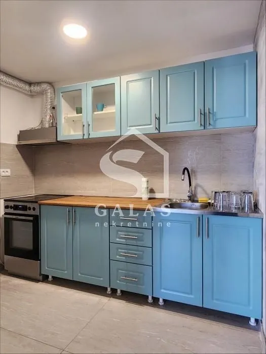 Kitchen with blue cabinets and a built-in stove.