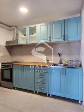 Kitchen with blue cabinets and a built-in stove. - image 14
