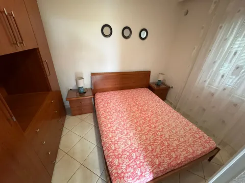 Furnished bedroom with a double bed, wardrobe, and nightstands. - image 5