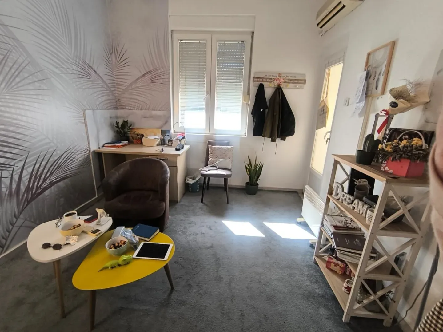 Small living room with a desk and carpet.