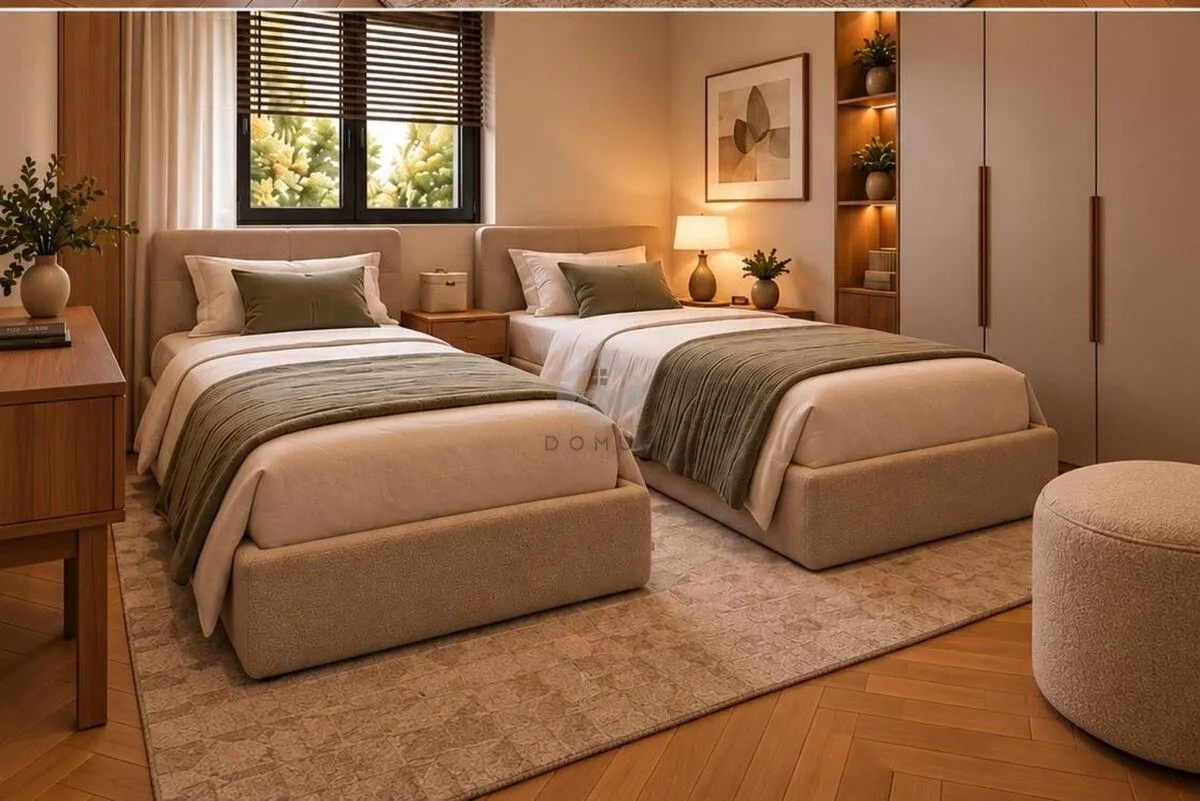 Bedroom with two single beds, a built-in wardrobe, and wooden flooring.