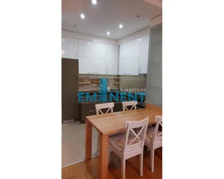 Kitchen with a dining table and white cabinetry. - image 3