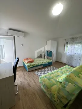 Furnished bedroom with a bed and a desk. - image 2
