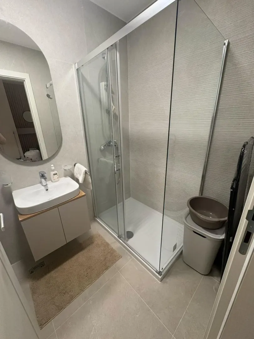 Modern bathroom equipped with a shower cabin and a vanity sink.