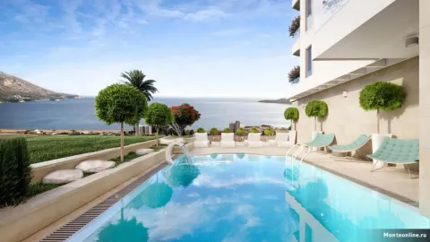 Swimming pool with sun loungers and sea view. - image 6