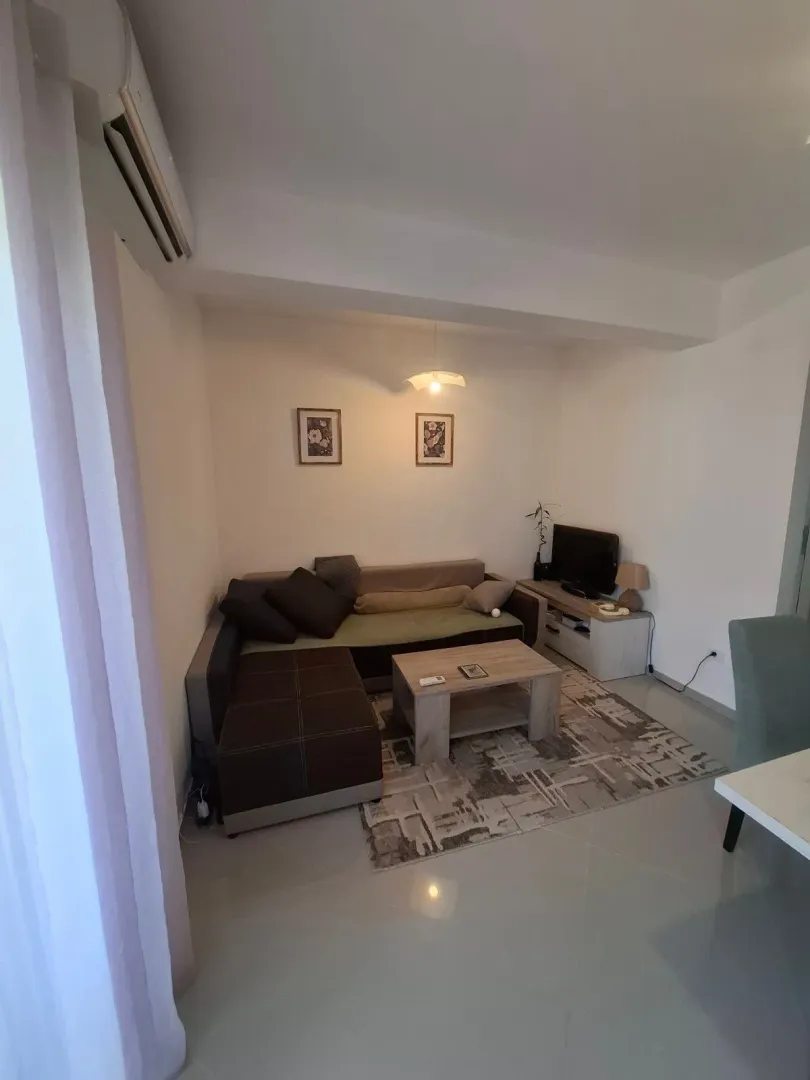 Living room with a sectional sofa, coffee table, and TV.