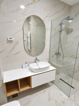 Modernly equipped bathroom with a washbasin and walk-in shower. - image 5