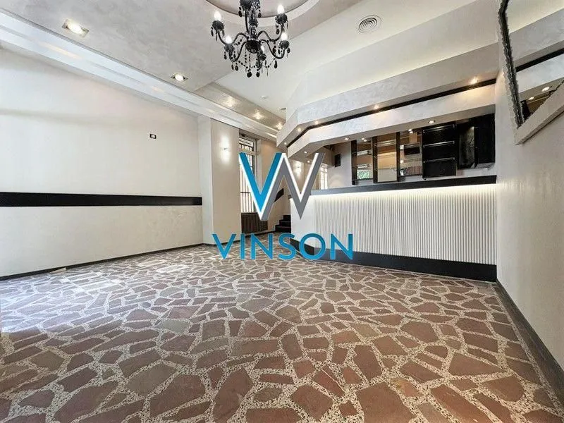Spacious living room with a bar counter and decorative lighting.
