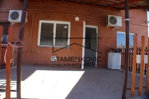 View of the exterior part of the house with a tiled terrace and entrance door. - image 2