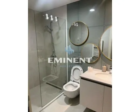 Modernly equipped bathroom with a walk-in shower and mirrors. - image 10