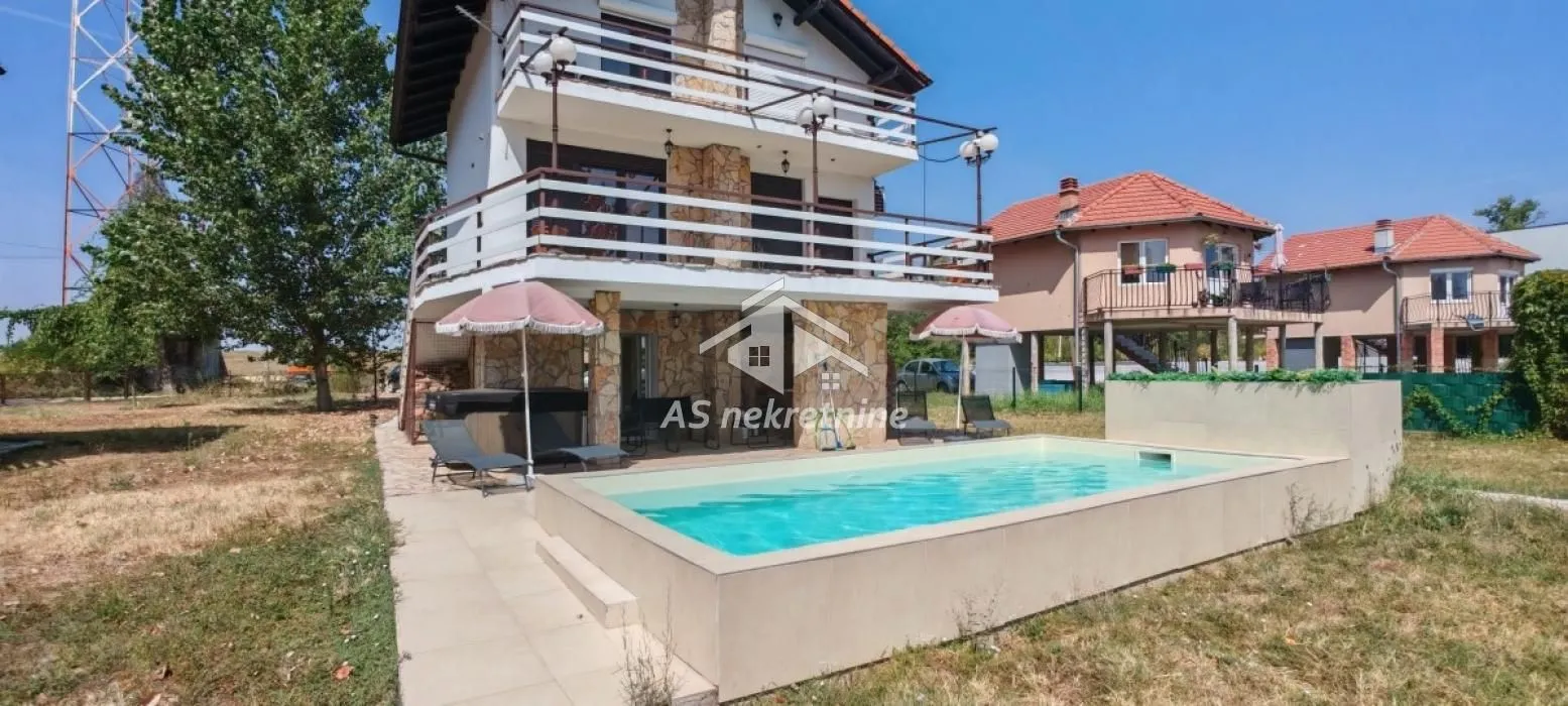 View of the house yard with a swimming pool and terrace.